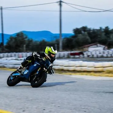 Man riding black sports bike in race track