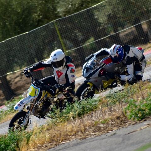 two bikers riding sports bikes in sports race