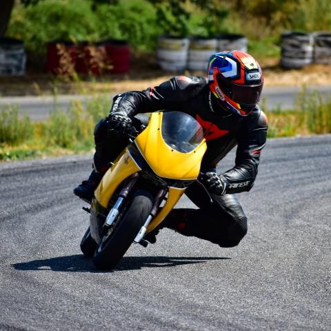 biker riding yellow sports bike in race track