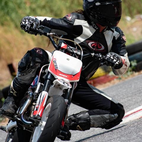 biker riding white motorbike in race track