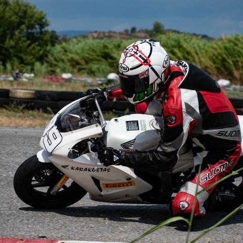 biker riding white sports bike in race track