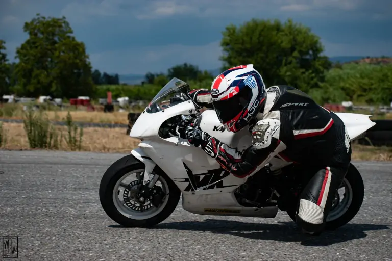 biker riding white sports bike in race track