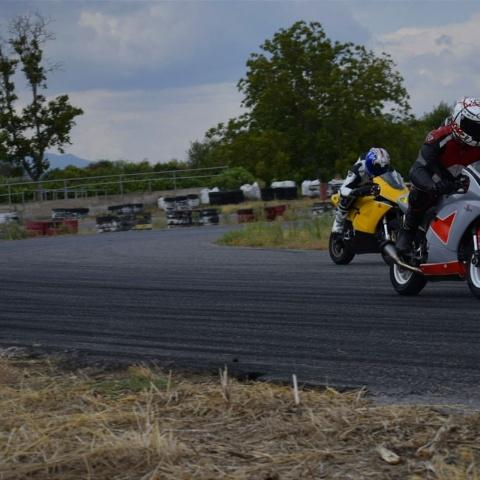Two bikers riding yellow and silver sports bikes in sports race
