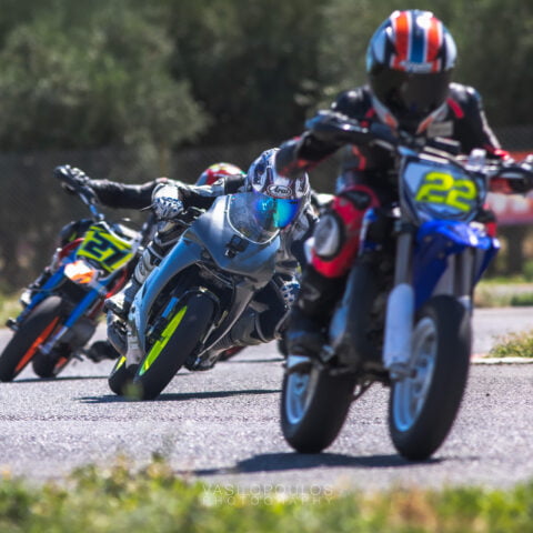 three riders exit of corner