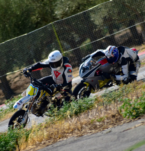two bikers riding sports bikes in sports race two bikers riding sports bikes in sports race